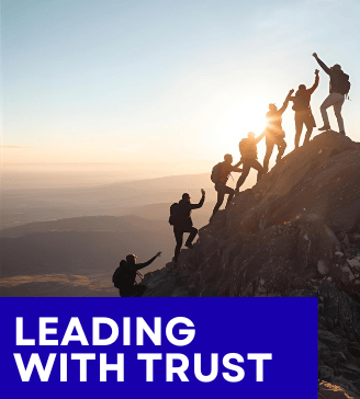 Photo of team  trusting each other to reach mountain peak