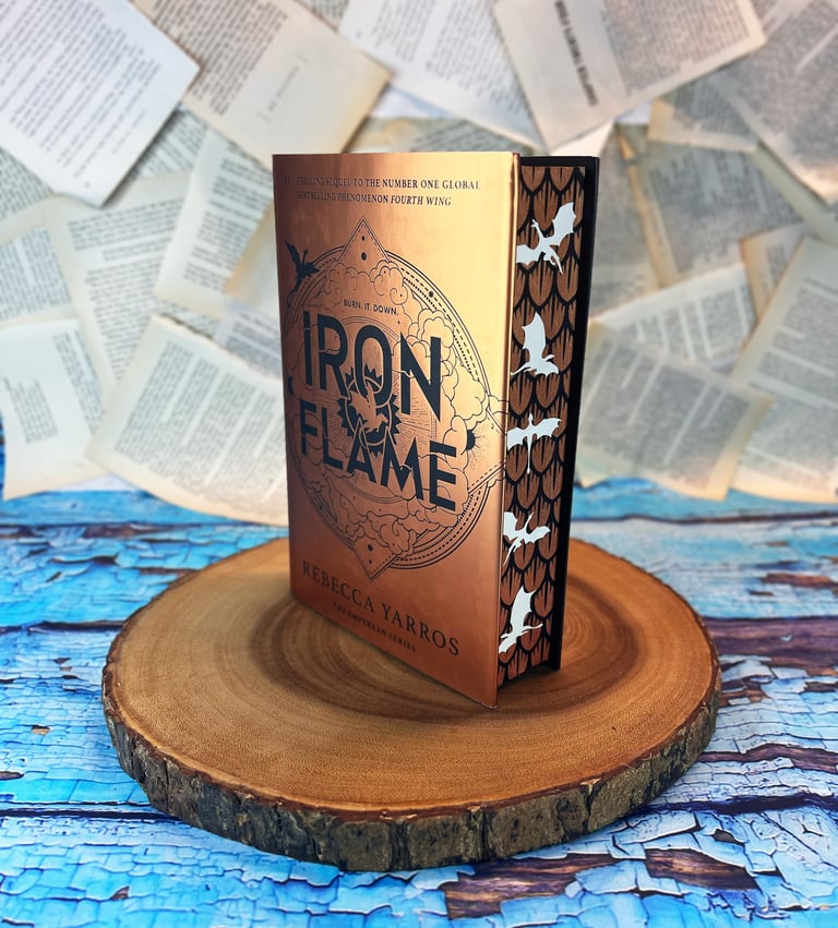 Iron Flame book with stenciled edges. gold scales with white dragons.