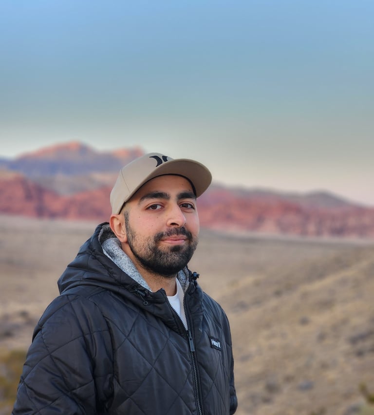 a man in a black jacket and a hat