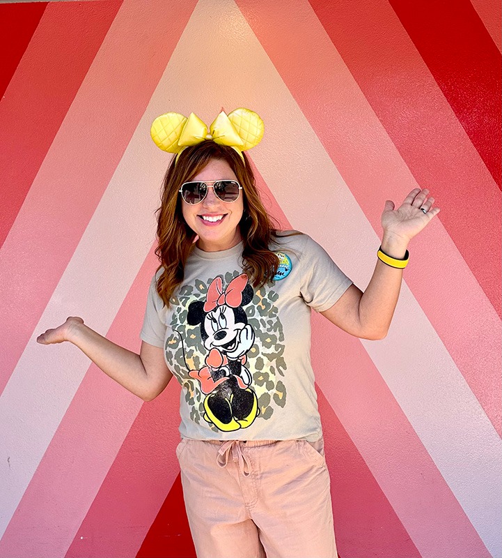 Karen Amundson in front of the "Future World" photo wall at EPCOT®.