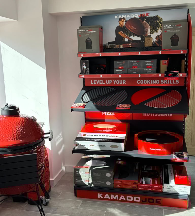 Kamado Joe accessory display at Outdoor BBQ Kitchens showroom in Southampton featuring charcoal, piz