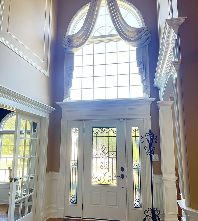 Custom crown molding, columns, and architectural trim in a two-story Monmouth County NJ foyer