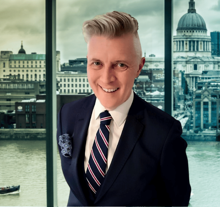 a man in a suit and tie with a boat in the background