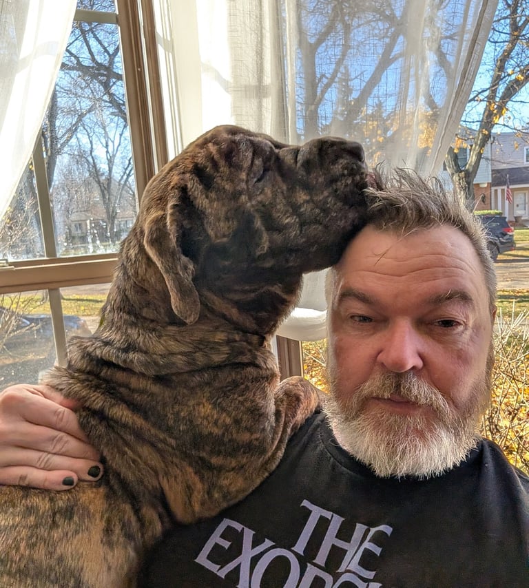 Marty and un-showered me somehow sharing a small chair in the frontroom. Fall 2025