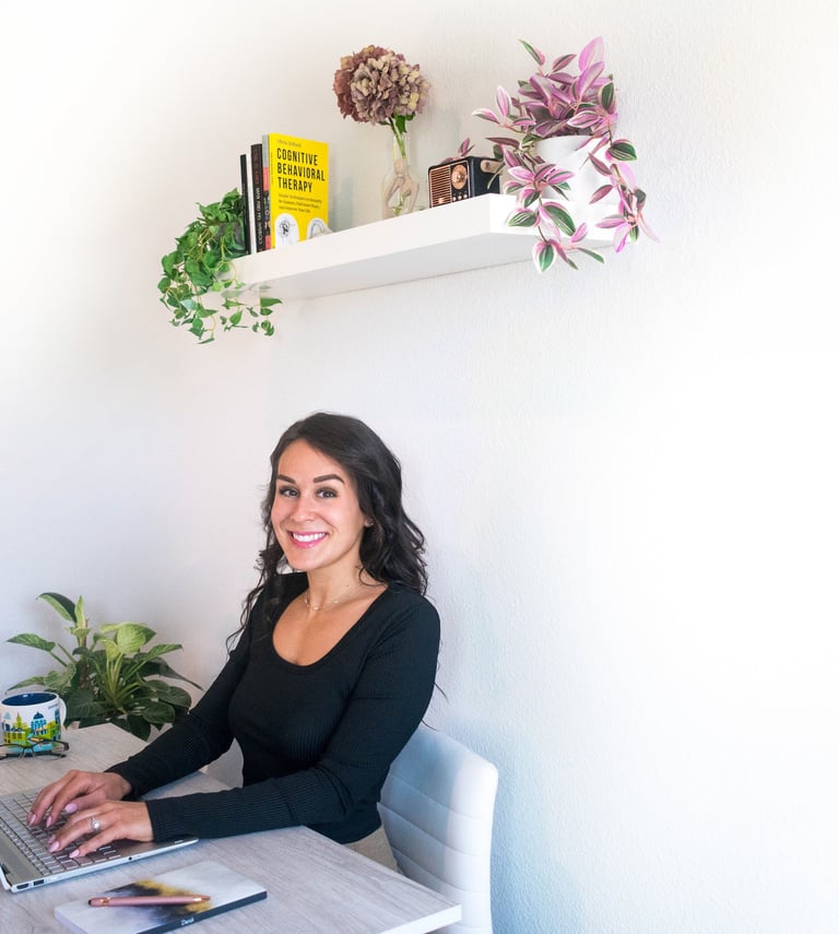 Woman typing on a laptop smiling