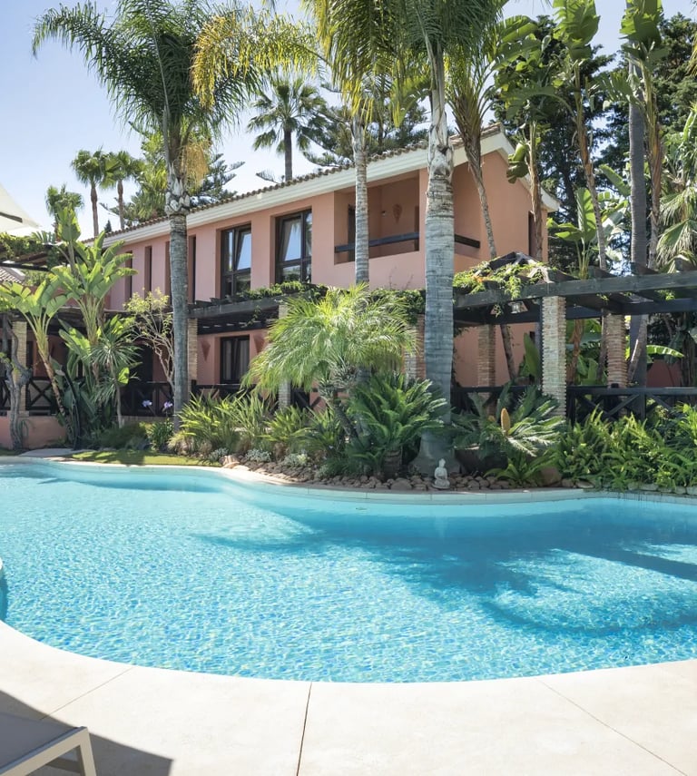 Saltwater swimming pool surrounded by tropical gardens at a private Marbella villa