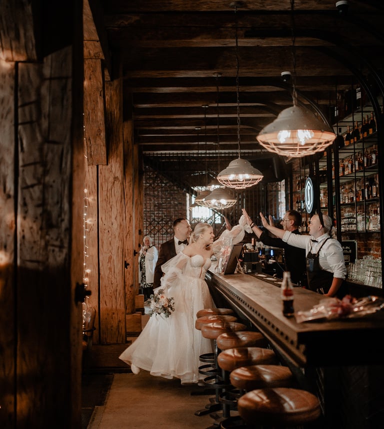 a bride and groomsmen are standing in a bar