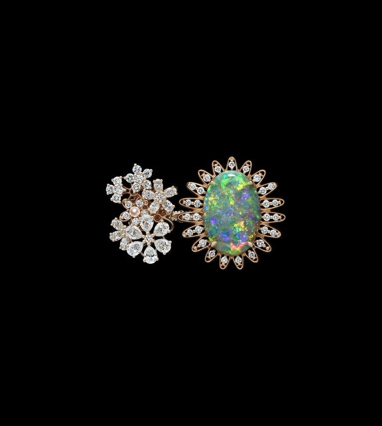 Dior ring with floral diamond design and large opal centerpiece.