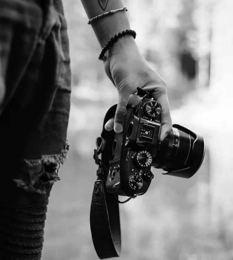 Street photographer carrying a DSLR camera in black and white