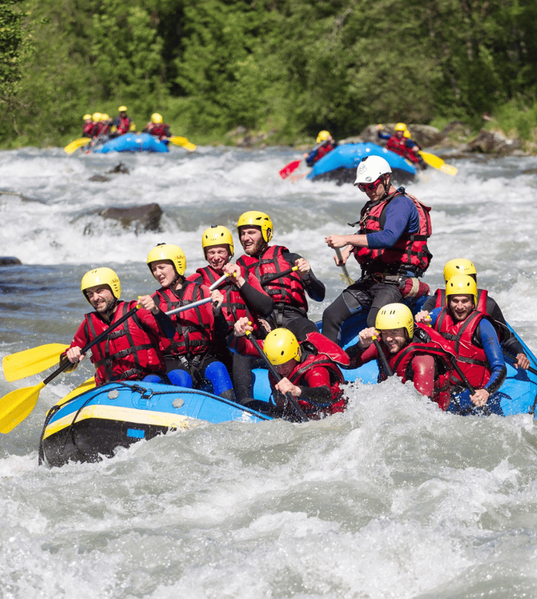 a group of people in rafters on a river