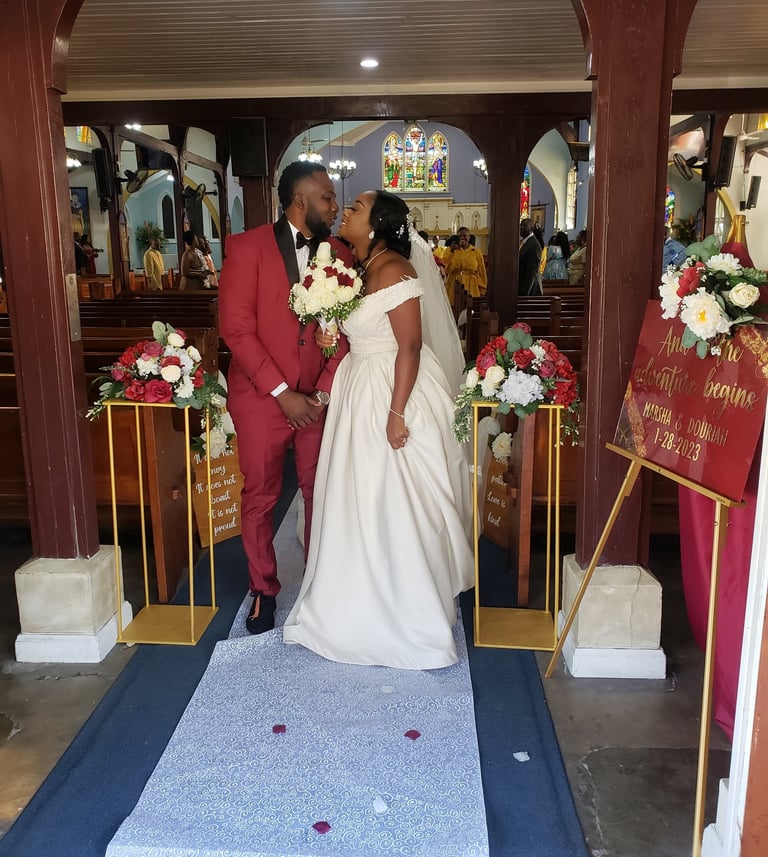 a bride and groom standing in front of a church