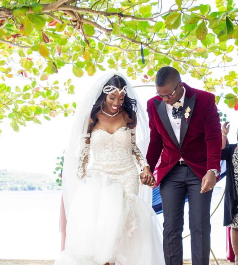 a bride and groom walking down the aisle of a beach wedding