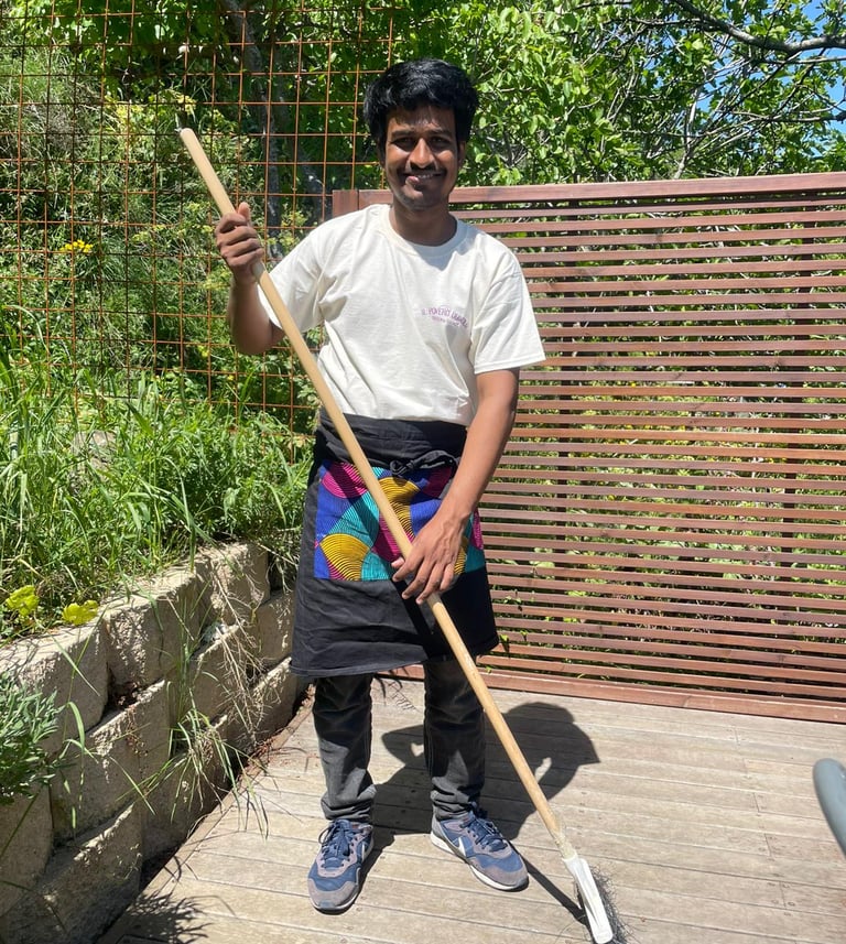 a man in a apron and apron holding a shovel