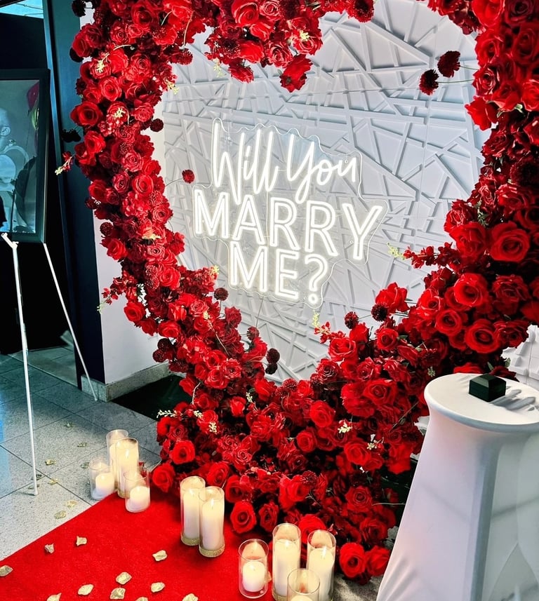 A heart-shaped arrangement of silk roses in shades of red,