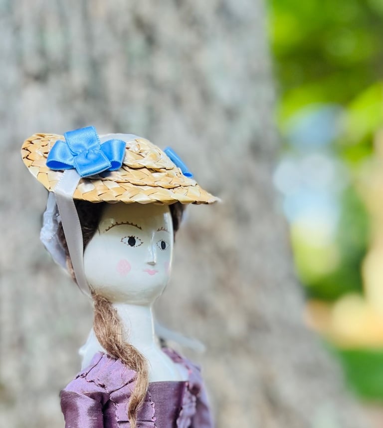 a doll doll with a hat on a tree