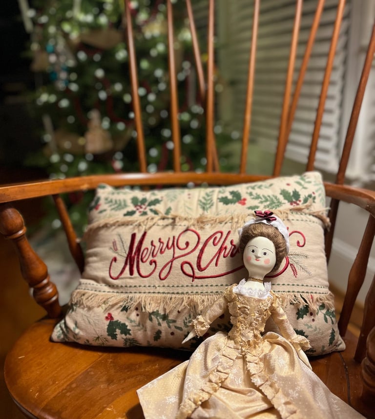 a doll doll sitting on a rocking chair