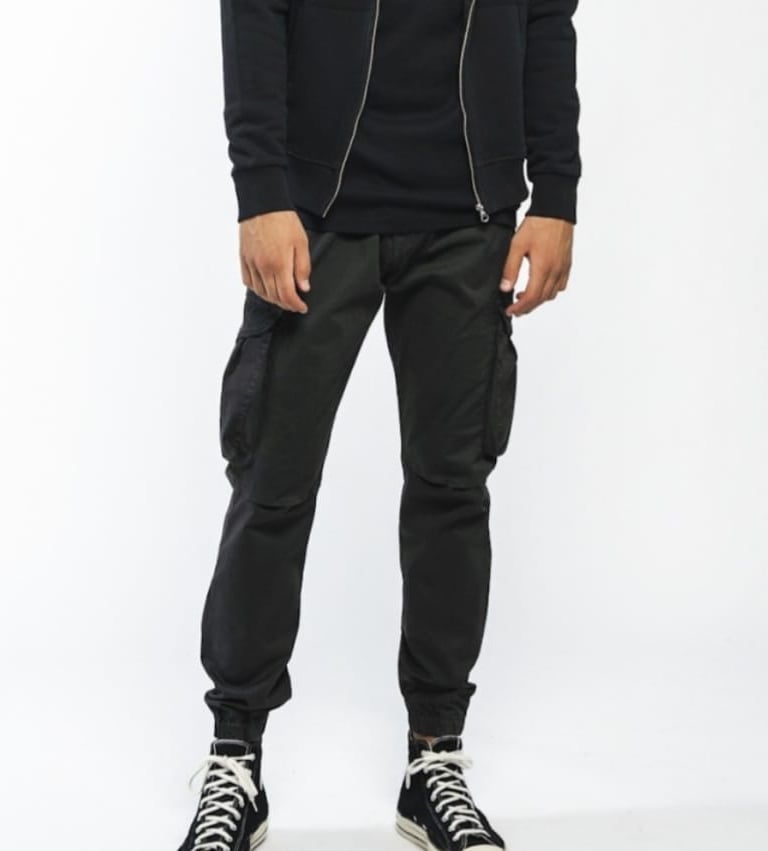 a man in a black hoodie and black pants