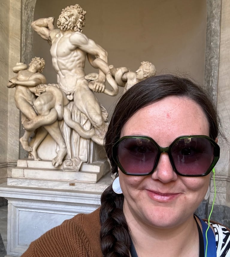 Cassie standing in front of Laocoon, a sculpture in the Vatican
