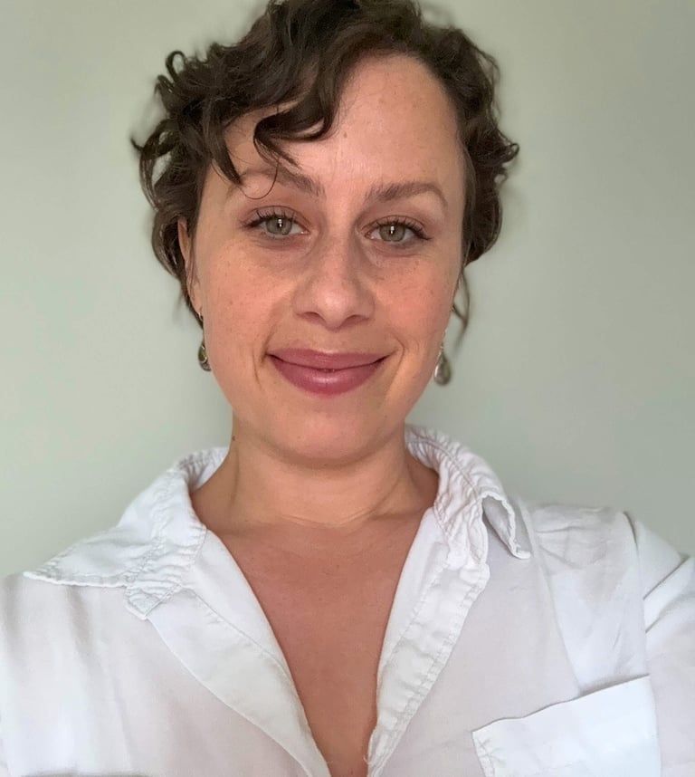 andree patenaude is a white woman and somatic therapist wearing a white shirt and smiling