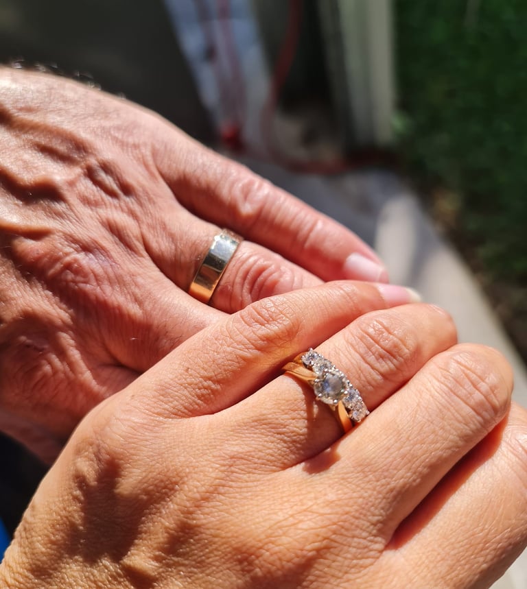Image of Danny and Lana Weller, holding hands showing wedding rings, after their wedding, Brisbane