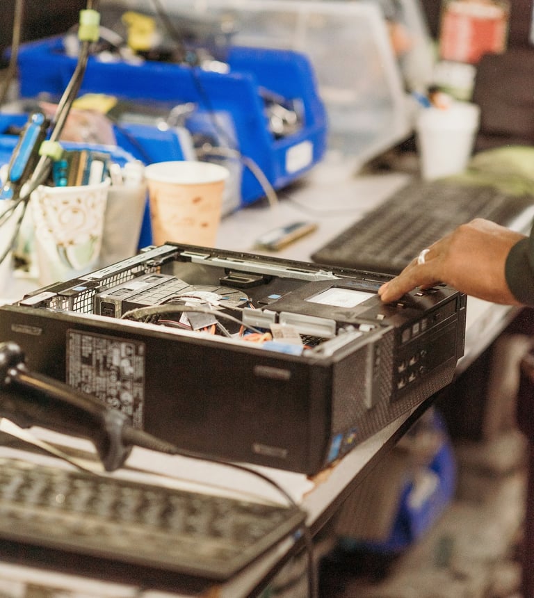 PC repair technician diagnosing a desktop computer on a workbench at PCWorkbench in Alexandria, VA.