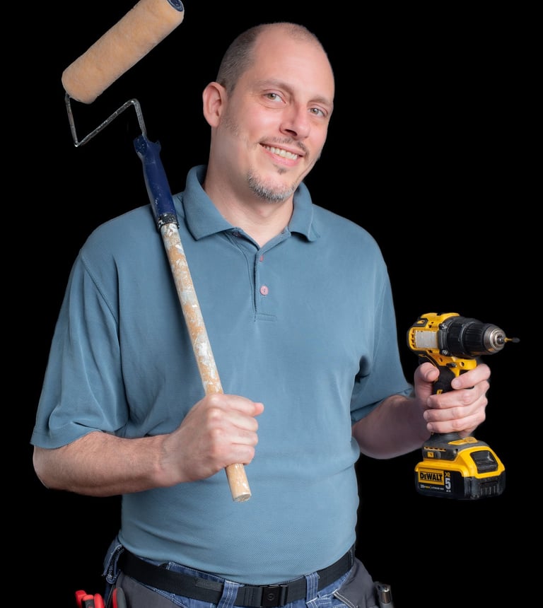 Portrait of Cyd holding a paint roller and a drill
