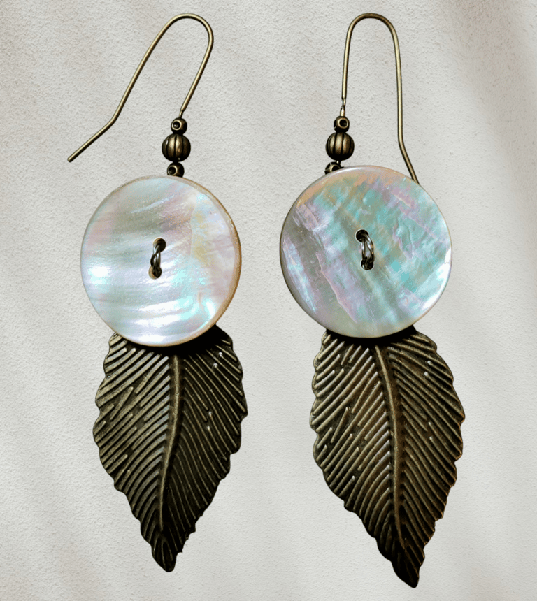 Iridescent mother of pearl shell and antique bronze leaf dangle earrings for boho jewelry fashion.