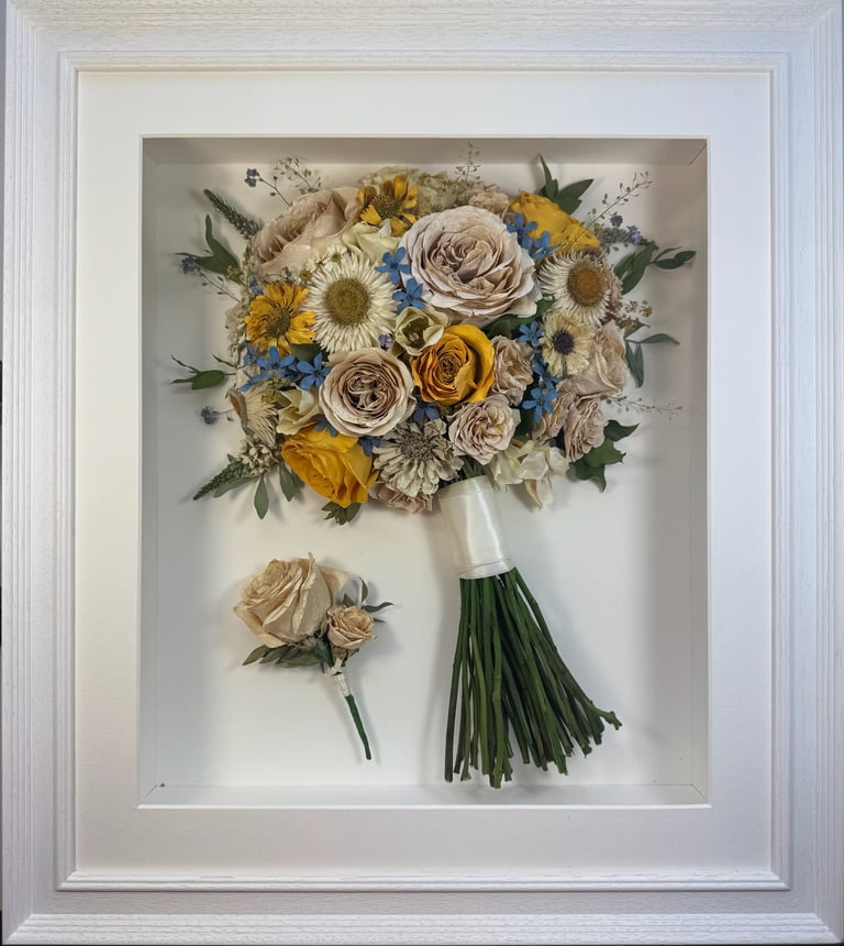 a Side view Style bouquet of flowers with buttonhole in a ridged white frame