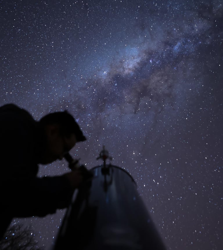 a man is looking at the stars in the sky