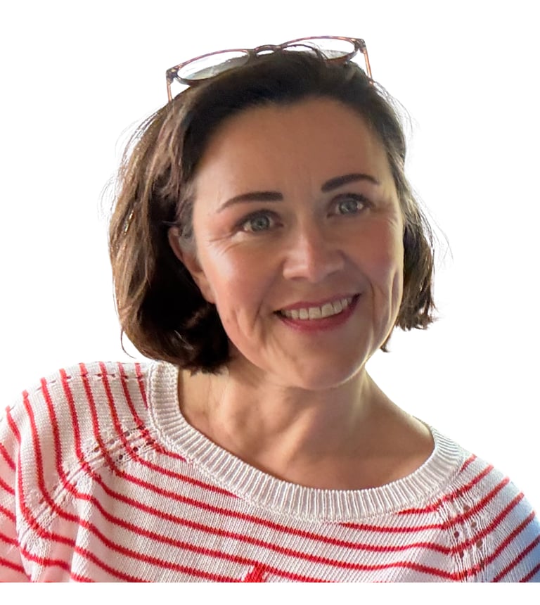 Smiling brunette woman wearing a red and white striped sweater and glasses on her head.