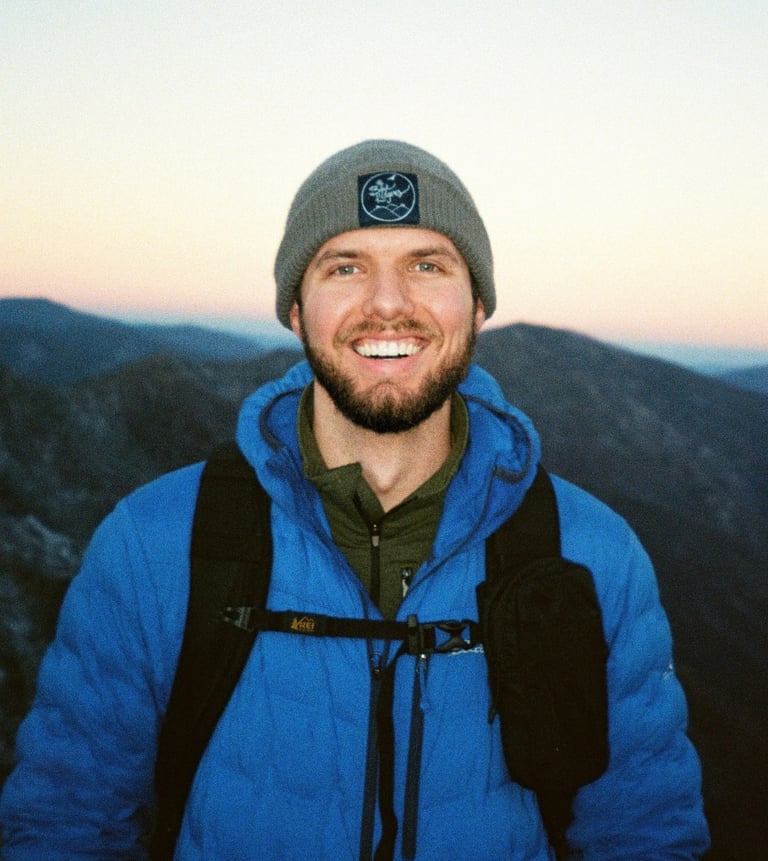 Nate Bowery standing in front of the Great Smoky Mountains during a winter hike