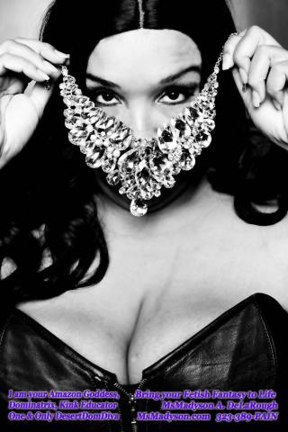 MsMadyson covering her face with a jeweled mask