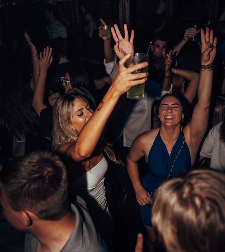 a woman in a white dress is dancing at a party