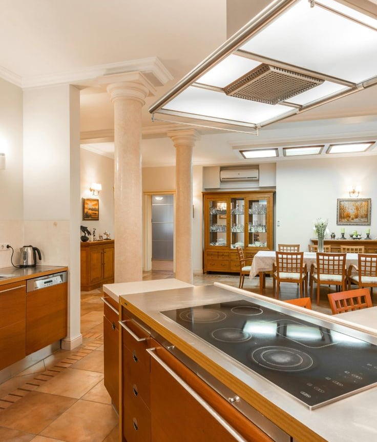 Warm modern kitchen lighting with pendant lamps above an island.