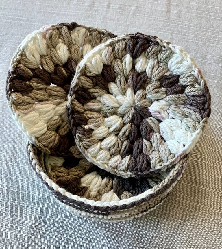 Beginner crochet drink coasters with basket in brown, tan, and cream colors