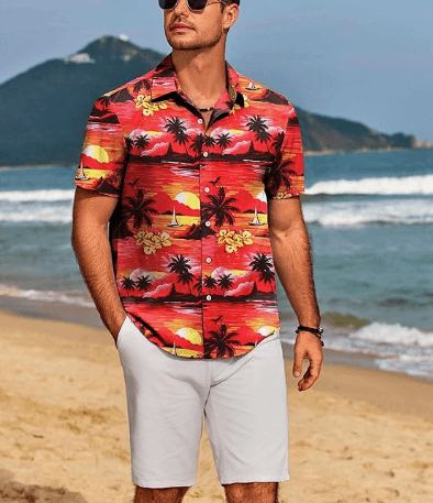 a man in a hawaiian shirt and sunglasses on a beach