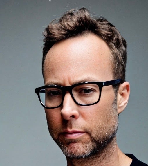a man with glasses and a black shirt
