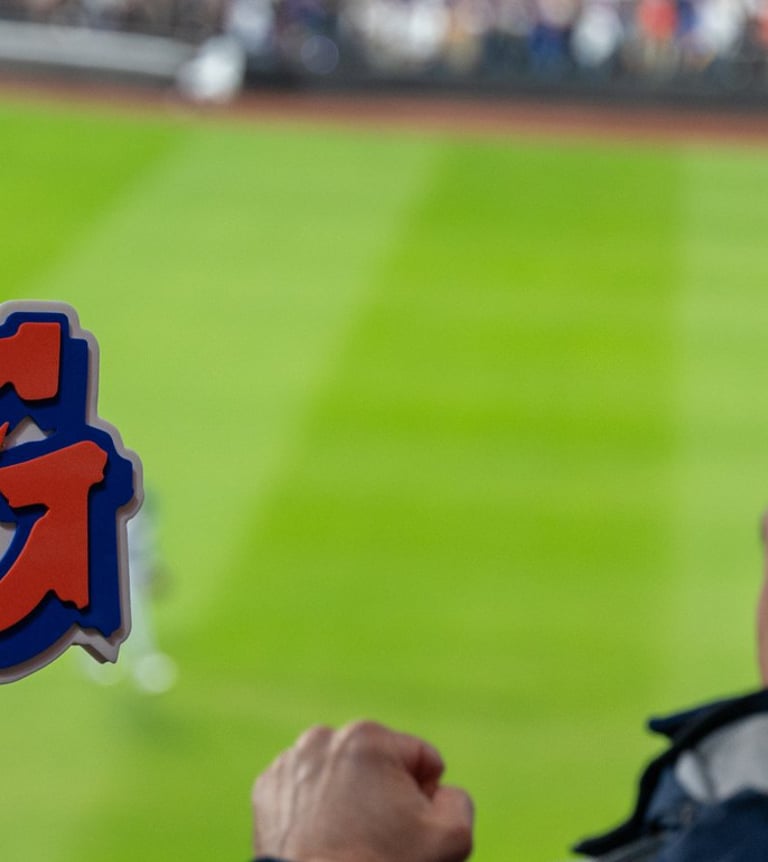 excited fans with a jose iglesias omg sign cheering the mets at citifield during nlcs game 5