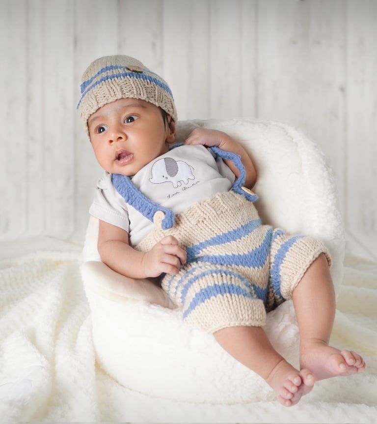 Newborn baby peacefully posed in a basket creating a dreamy and artistic portrait.