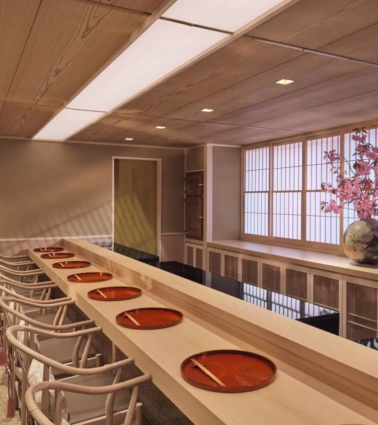 Minimalist sushi counter with traditional Japanese decor at an exclusive fine dining restaurant.