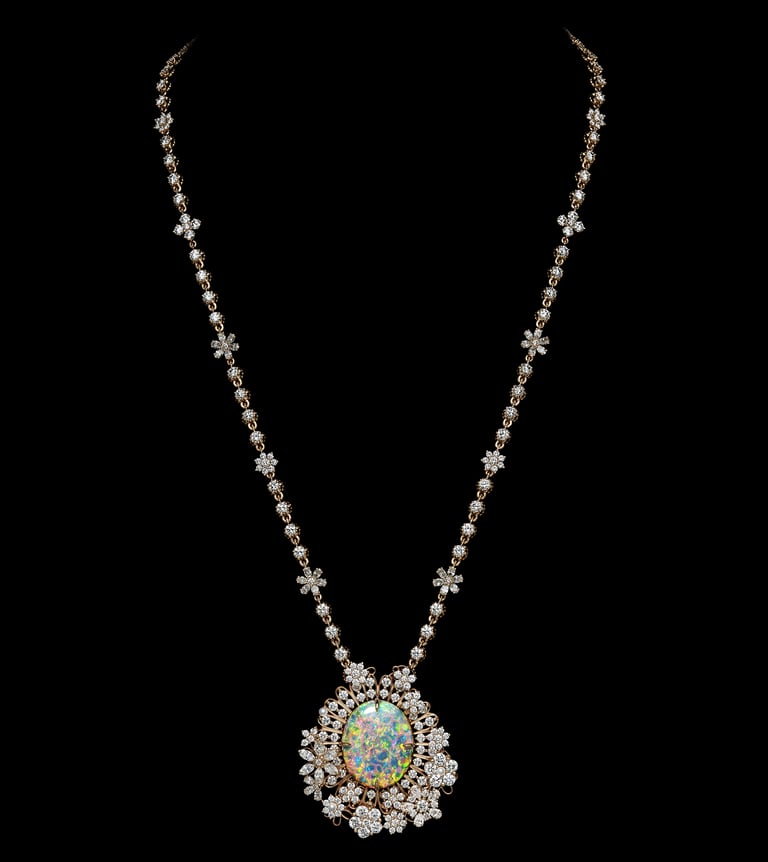 Dior Gold necklace with floral diamond accents and a large opal pendant..