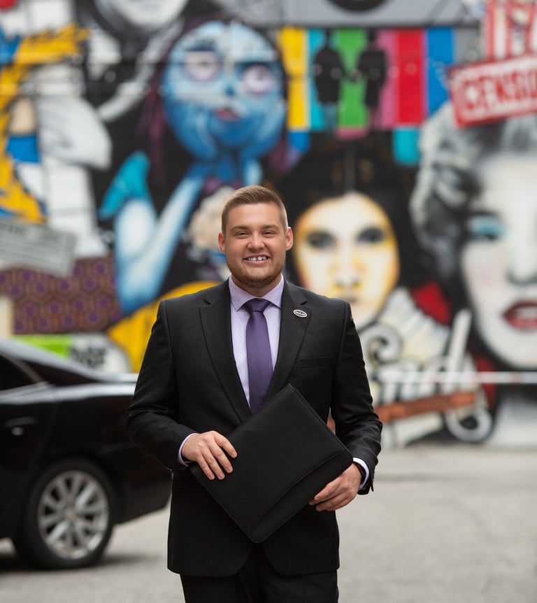 A man standing with a binder