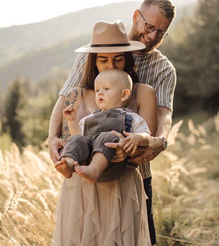 Mother and father holding their baby during an outdoor family photoshoot in the South Downs 