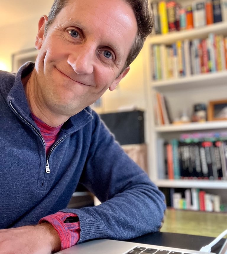 Marcus at desk with books in background