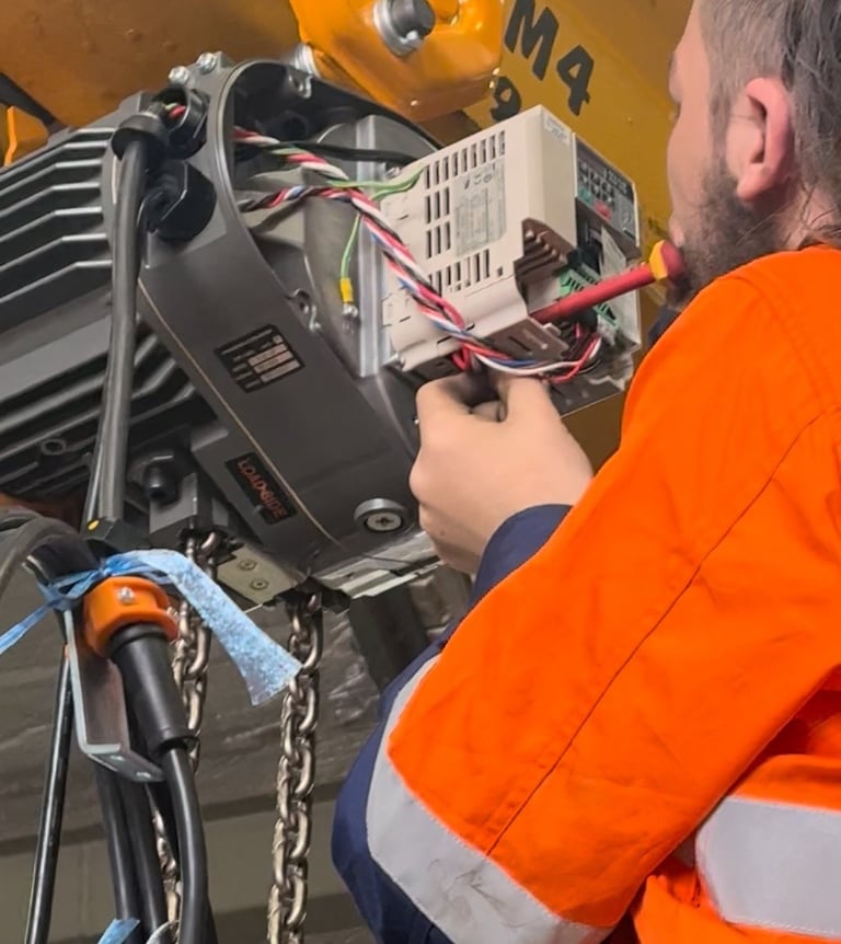 crane technician inspecting and adjusting electrical components