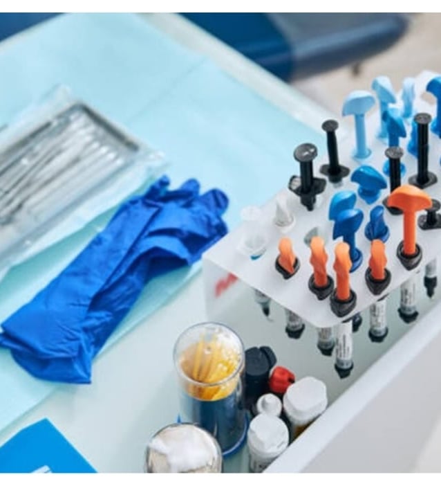 a table with a bunch of different types of dental instruments