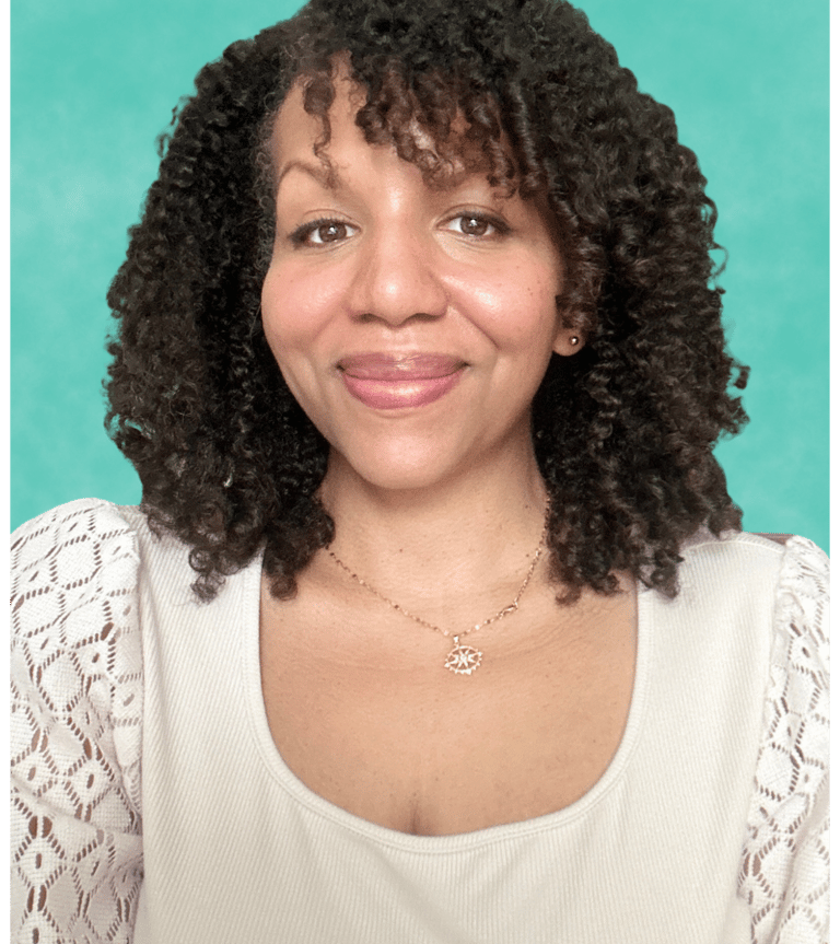 a woman with curly hair and a necklace