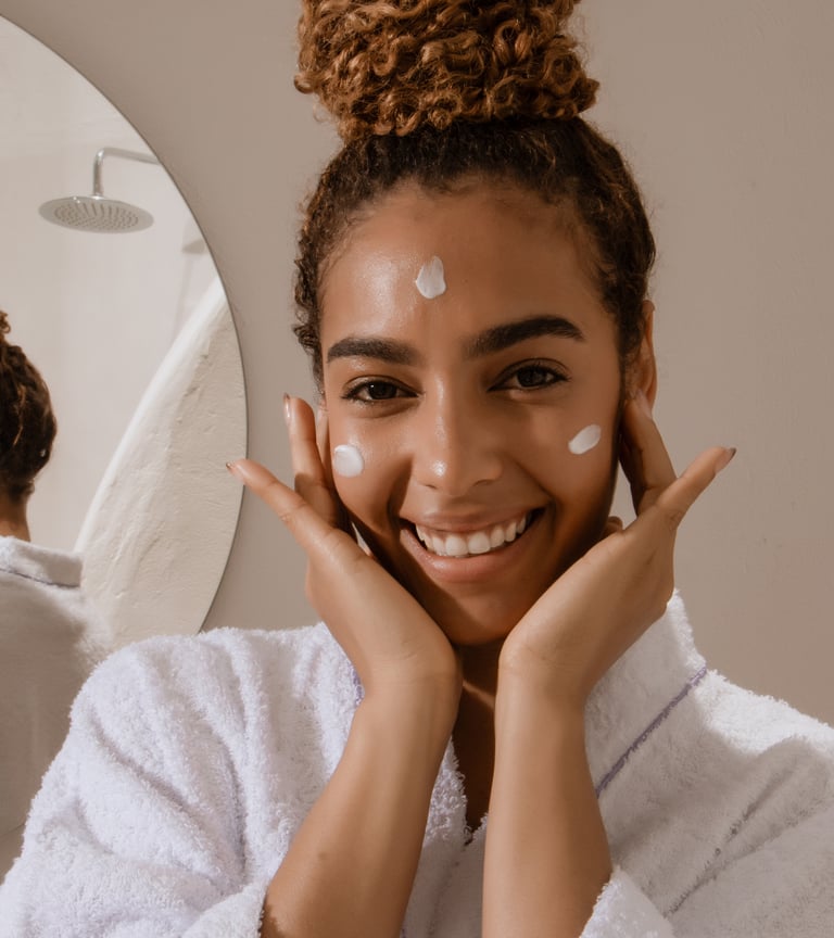 Woman in bathroom appyling azeliac acid serum to her face morning skincare routine