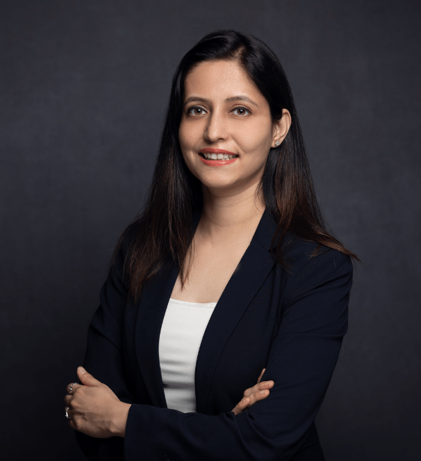 Dr Anam in a black suit and white top