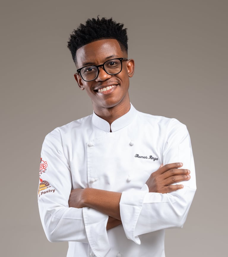 a man in a chef's uniform and glasses